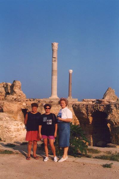 Three tourists in front of the Antonine Baths columns in Carthage