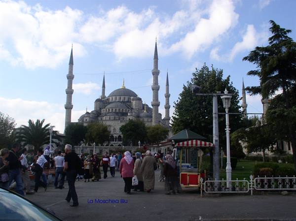 Tourists stroll in the garden in front of Istanbul's Blue Mosque
