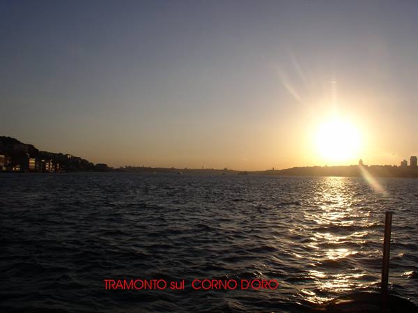 Low sun over the Golden Horn, golden reflections on the water, shoreline houses