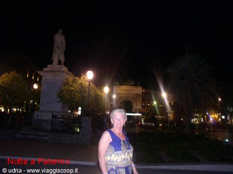 Woman at night near the statue in Piazza Ruggero Settimo, Politeama theatre