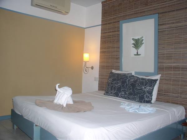Hotel room with double bed and towel folded into an elephant shape