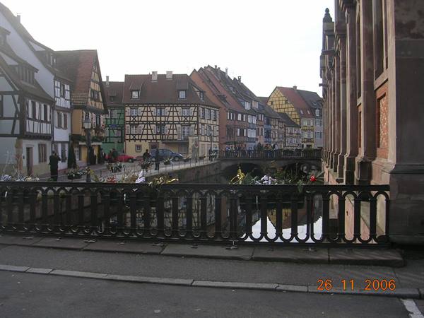 Half-timbered houses along Colmar canal, wrought iron footbridge