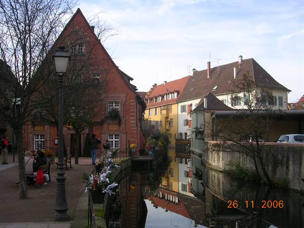 Half-timbered houses along the Petite Venise canal in Colmar, reflected in the water