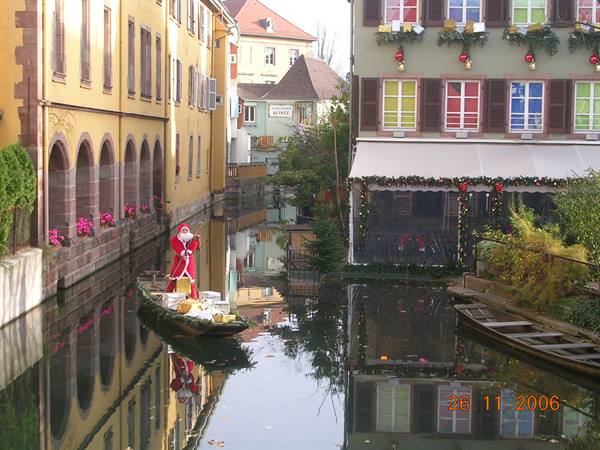 Santa Claus on a decorated boat along the canal in Colmar's Petite Venise