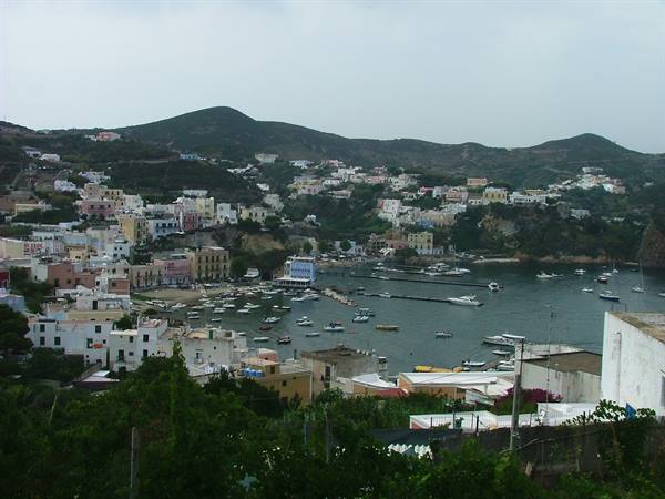 Ponza harbour with anchored boats and colorful houses on the hillside