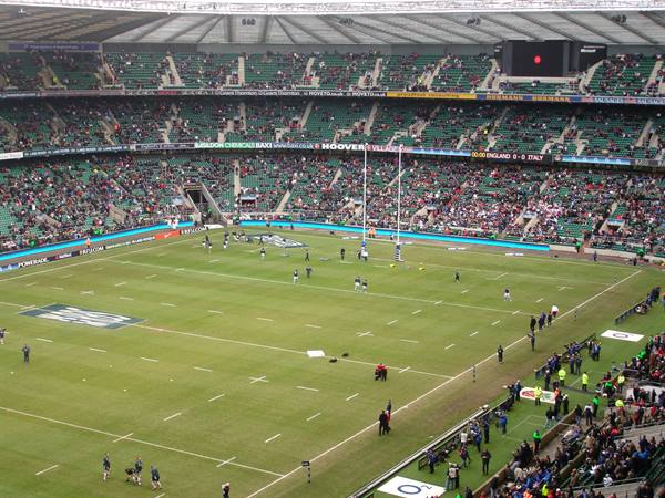 Rugby match at Twickenham, players on the pitch under the covered stands
