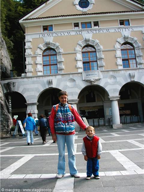 Woman and child in front of the Postojna Cave entrance building