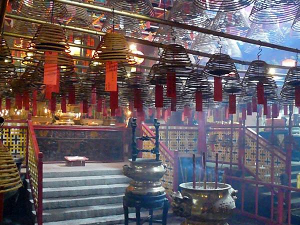 Incense coils hanging inside Man Mo Temple, bronze burners and drifting smoke