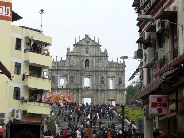 Stone facade of St. Paul's ruins, crowds on the steps, Macau