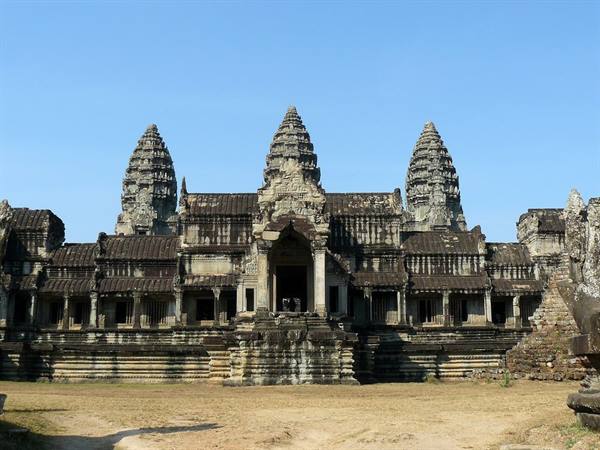 Angkor Wat's stone towers rising under a clear blue sky