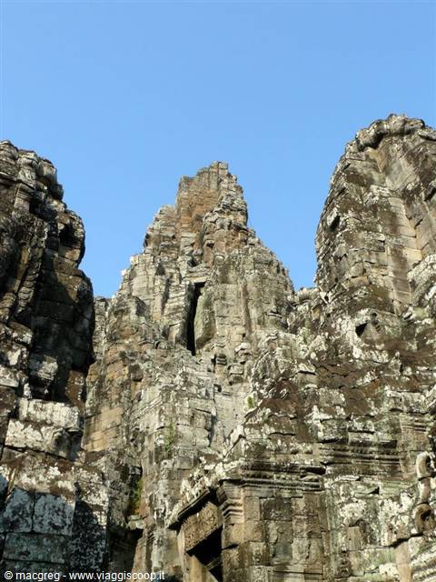 Stone towers with carved faces at Bayon temple, Angkor, morning light