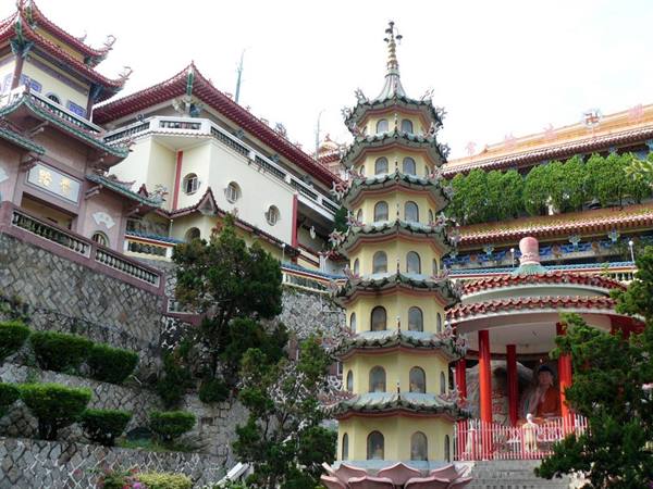 Multi-tiered pagoda at Kek Lok Si Temple in Penang, among red pavilions and gardens