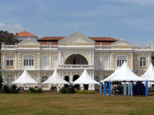 Yellow colonial Town Hall in George Town, Penang, with white tents on the lawn