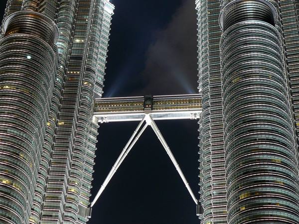 Illuminated skybridge connecting the Petronas Towers at night in Kuala Lumpur