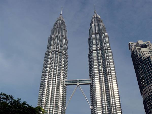 The Petronas Towers in Kuala Lumpur, shiny steel against the blue sky