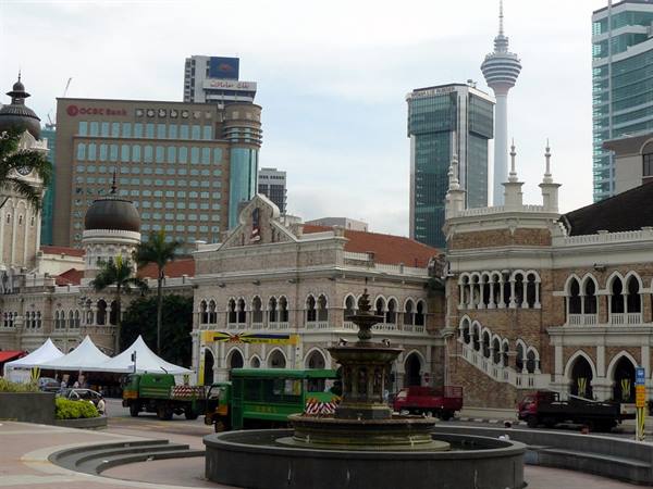 Fountain on Merdeka Square in Kuala Lumpur, colonial buildings and tower behind