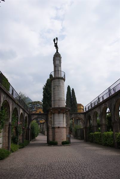 Stone column with winged statue between arched porticoes, Vittoriale degli Italiani