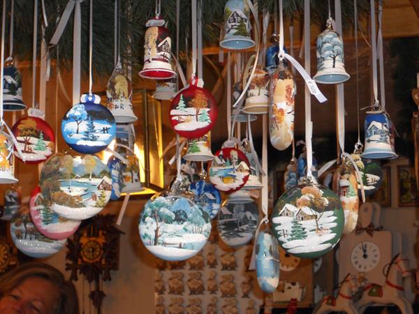 Hand-painted glass baubles and bells hanging at a Christmas market