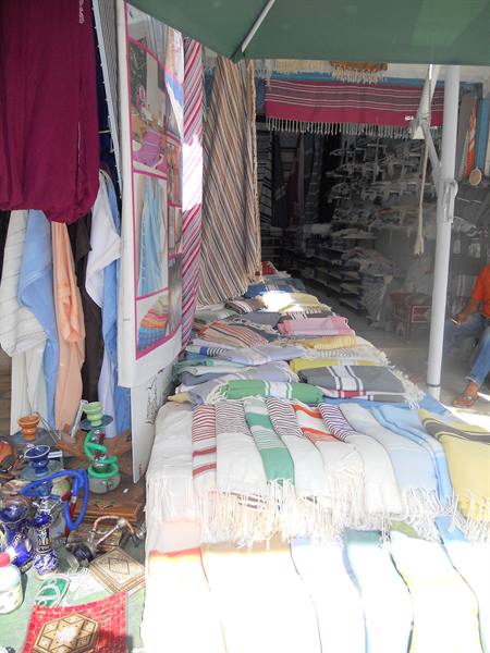Street stall selling handwoven towels and hookahs