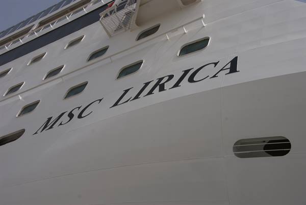 White hull of MSC Lirica ship with portholes and ladder, daylight