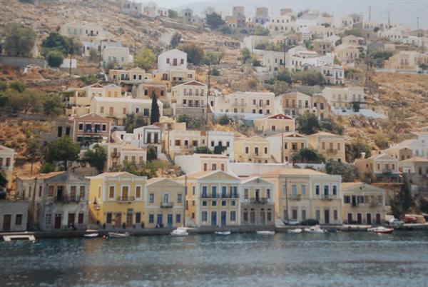 Pastel neoclassical houses on the hillside above Symi harbour