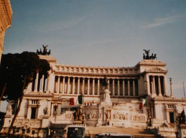 The Vittoriano in Rome, white marble monument with chariot statues and Italian flags