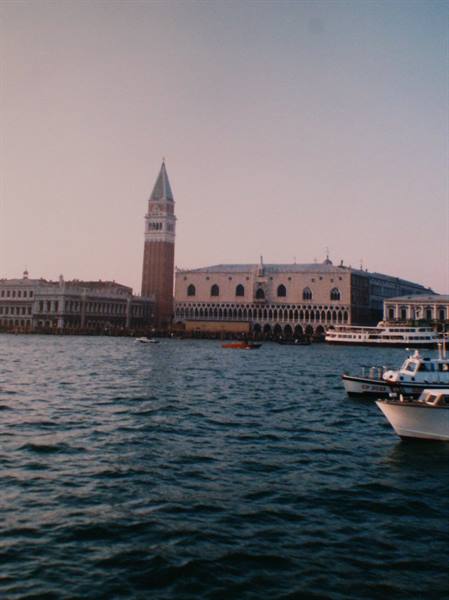 St Mark's Campanile and Doge's Palace in Venice seen from the water, boats nearby