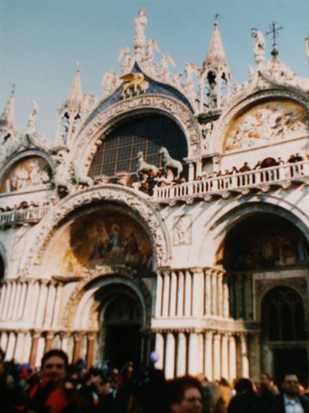 Crowds gather before the marble facade of St Mark's Basilica in Venice