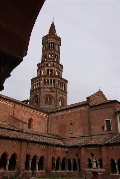Octagonal brick bell tower of Chiaravalle Abbey rising above the arched cloister