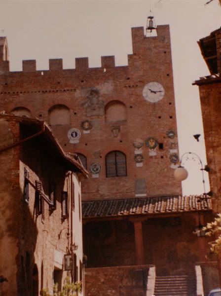 Certaldo's Palazzo Pretorio, brick facade with coats of arms, clock and bell tower