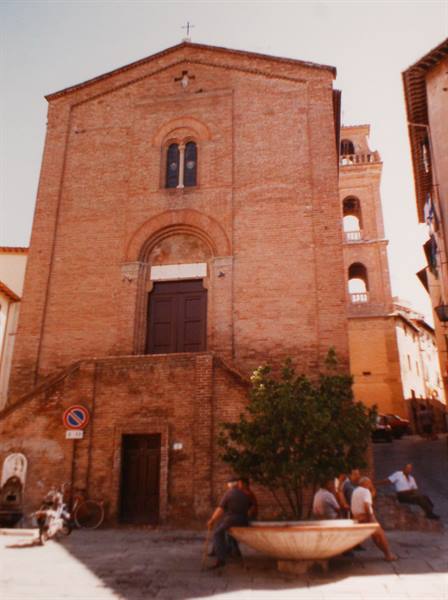 Brick church with staircase, people sitting beside the stone fountain