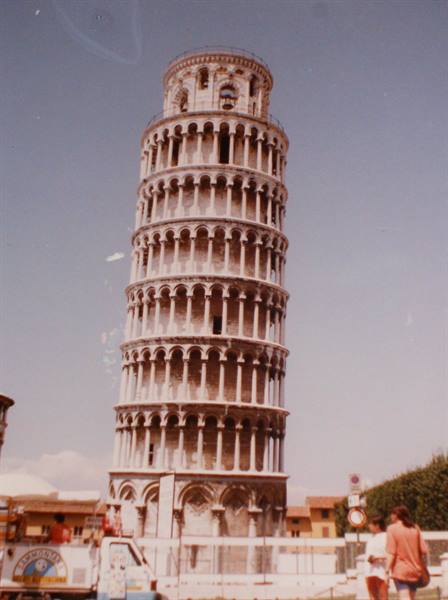The white marble Leaning Tower of Pisa under a blue sky