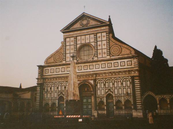 Marble facade of Santa Maria Novella in Florence, obelisk in front, evening light