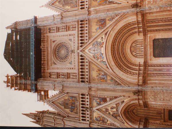 Orvieto Cathedral facade with golden mosaics and rose window, rotated photo