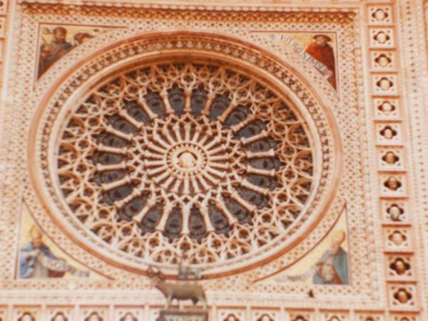 Gothic marble rose window and mosaics on Orvieto Cathedral facade