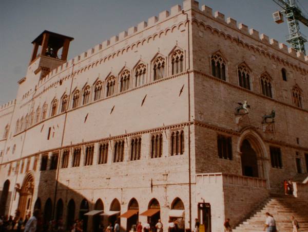 Palazzo dei Priori in Perugia, stone Gothic facade with arched windows and crowded steps