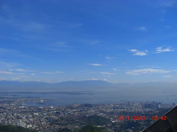 Rio de Janeiro: city, bay and long bridge under blue sky with scattered clouds