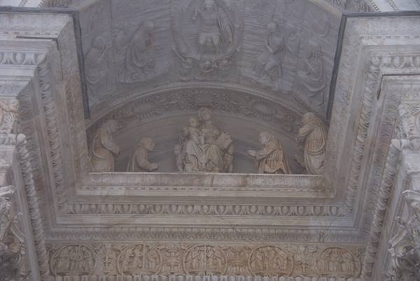 Marble relief of Madonna and Child with saints on the cathedral facade