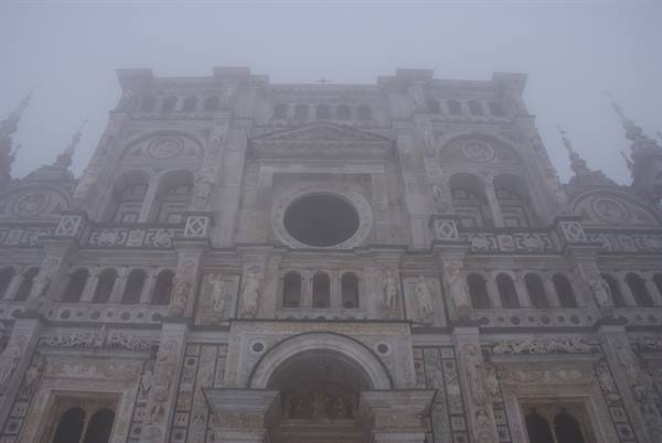 Marble facade of Certosa di Pavia shrouded in thick fog