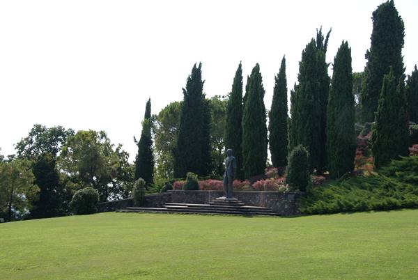 Statue on stone steps among cypresses in Villa Serbelloni park, Bellagio