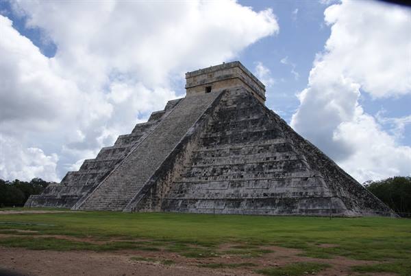 Kukulkan pyramid at Chichen Itza, limestone steps under white clouds
