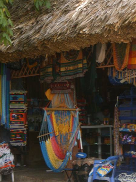 Colorful hammock hanging under a thatched roof of a craft market