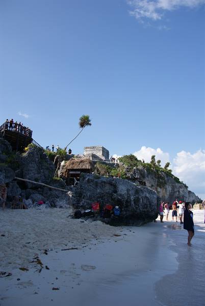 Tourists on the beach below the Mayan ruins of Tulum