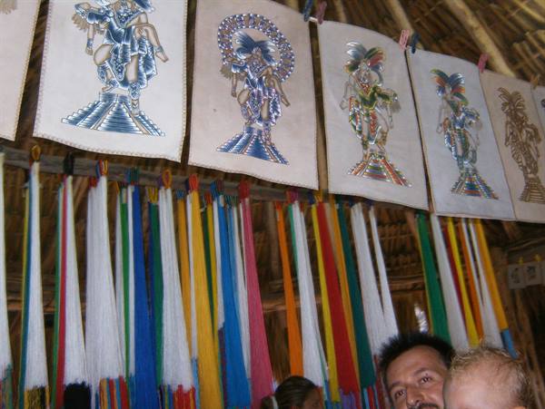 Colorful hammocks and bark paintings hanging at a Maya craft market