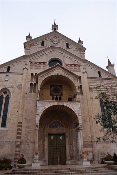 Romanesque facade of Verona Cathedral with Gothic portal under grey sky