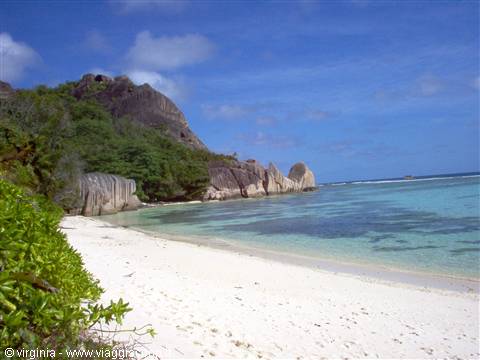 White sand beach with sculpted granite rocks and turquoise water, Seychelles