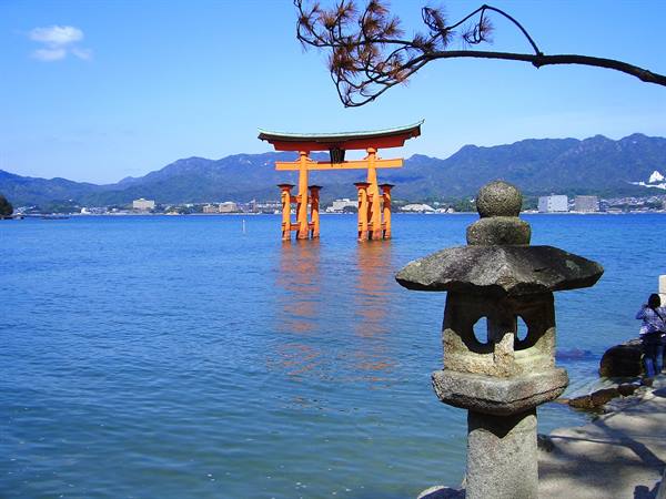 Stone lantern and red floating torii gate at Miyajima