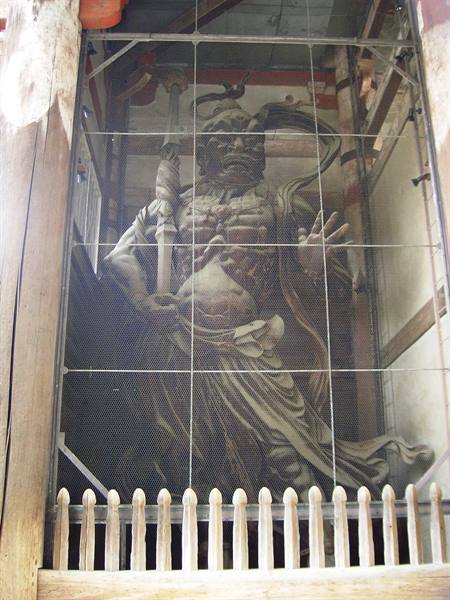 Wooden Niō guardian statue behind protective wire mesh, Todai-ji temple, Nara