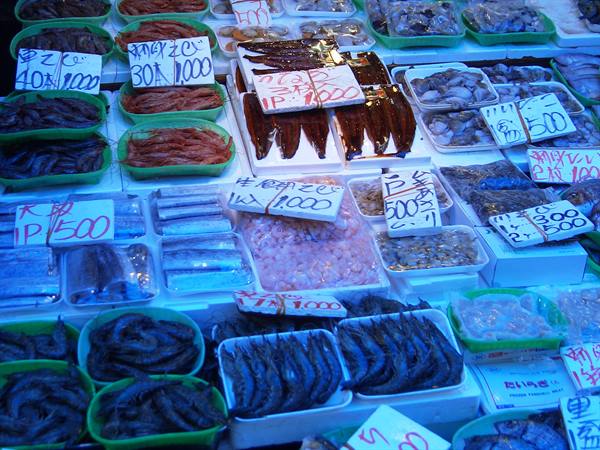 Fish market stalls with shrimp and dried fish, handwritten price tags