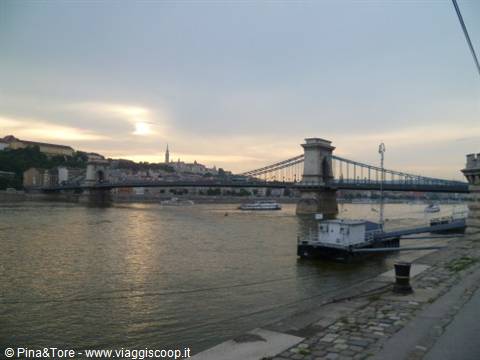 Budapest: the Chain Bridge over the Danube at dusk, boats moored along the embankment